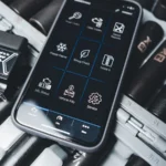 Close-up of a smartphone showing car diagnostic app with OBD2 scanner in a garage setting — SSK Mechanics guide to Check Engine Light On? Here's What It Actually Means