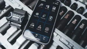 Close-up of a smartphone showing car diagnostic app with OBD2 scanner in a garage setting — SSK Mechanics guide to Check Engine Light On? Here's What It Actually Means