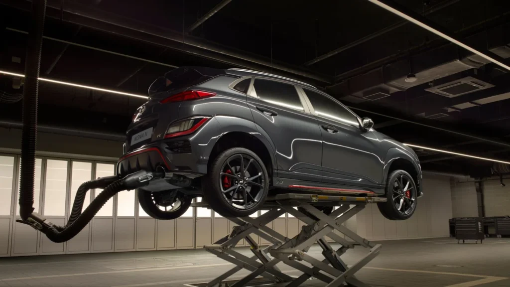 A sleek car on a lift in a high-tech automotive garage — SSK Mechanics guide to AdBlue Warning Light: What It Means and What Happens If You…