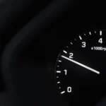 A detailed view of a car tachometer showing RPM with tire pressure warning — SSK Mechanics guide to EV Warning Light On: What It Means and When to Stop Driving