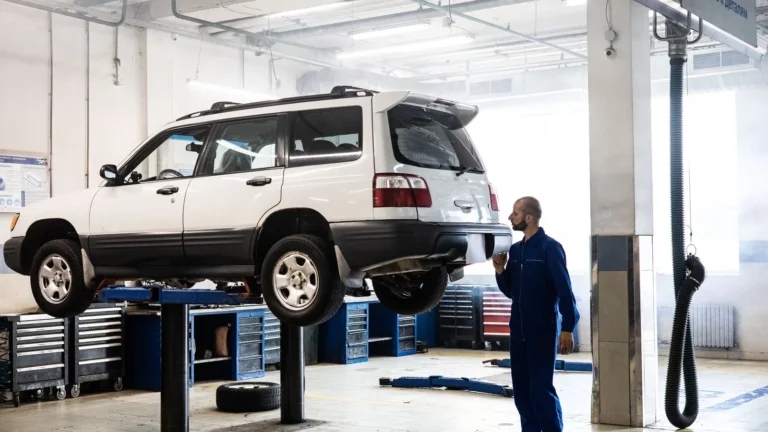 Mechanic inspecting a lifted SUV in a modern auto repair garage — SSK Mechanics guide to How to Check a Car's MOT History Before You Buy It