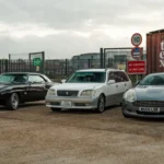 A collection of vintage and modern cars displayed in a UK parking lot, showcasing automotive history — SSK Mechanics guide to Can You Drive Without a Valid MOT? Tax, Insurance and the Law