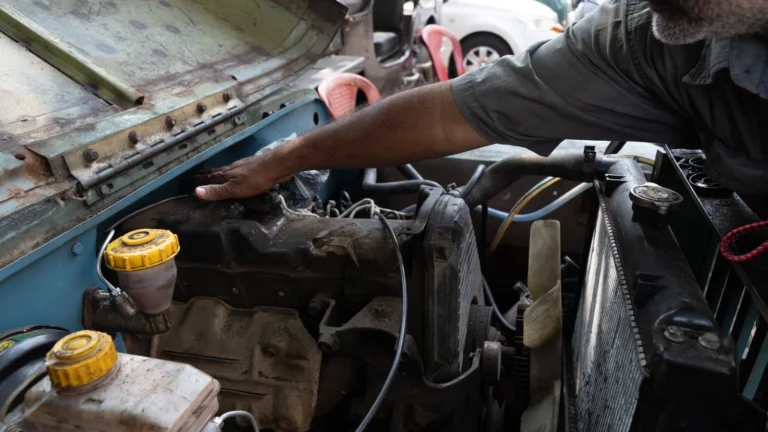 A mechanic tuning a jeep engine in an outdoor setting, highlighting vehicle maintenance — SSK Mechanics guide to How to Check Your Antifreeze and Coolant Levels
