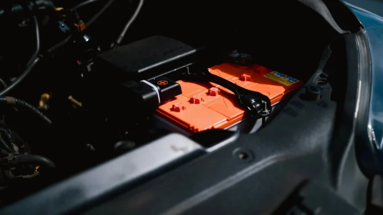 Close-up of a 12-volt battery inside a vehicle compartment — SSK Mechanics guide to repeated 12V battery discharge in electric cars