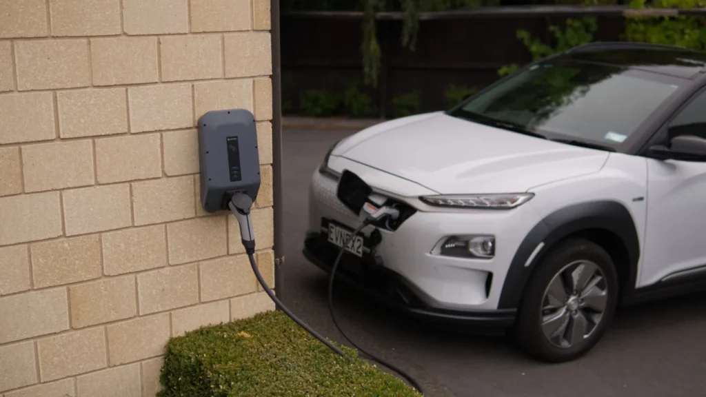A white electric car charging at a station in Christchurch, New Zealand, showcasing modern… — SSK Mechanics guide to Home Charging vs Public Charging: What Actually Differs