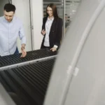 Salesman and client inspecting a pickup truck in a car dealership, discussing features — SSK Mechanics guide to What Is a Pre-Purchase Vehicle Inspection and Do You Need One