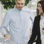 Professional interaction between a client and salesperson in a car dealership setting — SSK Mechanics guide to Buying a Car Privately? Here Are the Red Flags to Watch For