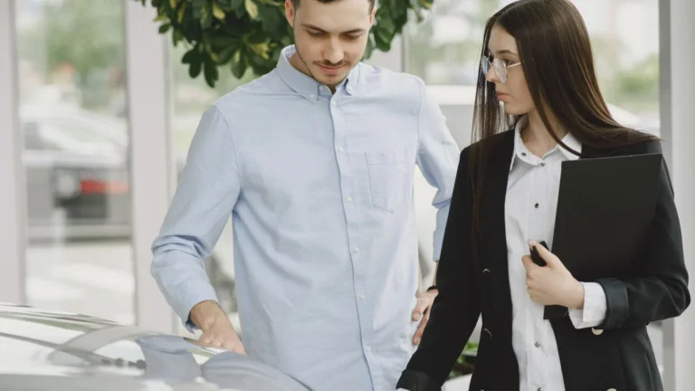 Professional interaction between a client and salesperson in a car dealership setting — SSK Mechanics guide to Buying a Car Privately? Here Are the Red Flags to Watch For
