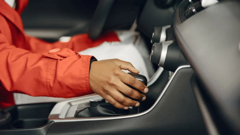 Close-up view of a person shifting gears in a car interior, illustrating driving expertise — SSK Mechanics guide to Test Driving a Used Car: What to Look and Listen For