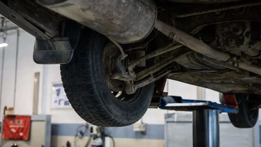 Close-up of car's undercarriage in a service station for repair and maintenance — SSK Mechanics guide to Bradford Clean Air Zone: What Every Driver Needs to Know…