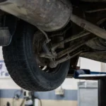 Close-up of car's undercarriage in a service station for repair and maintenance — SSK Mechanics guide to Bradford Clean Air Zone: What Every Driver Needs to Know…