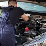 Close-up of mechanic repairing a car engine. Outdoor setting during the day — SSK Mechanics guide to Mobile Mechanic Reviews: How to Check if a Company Is…