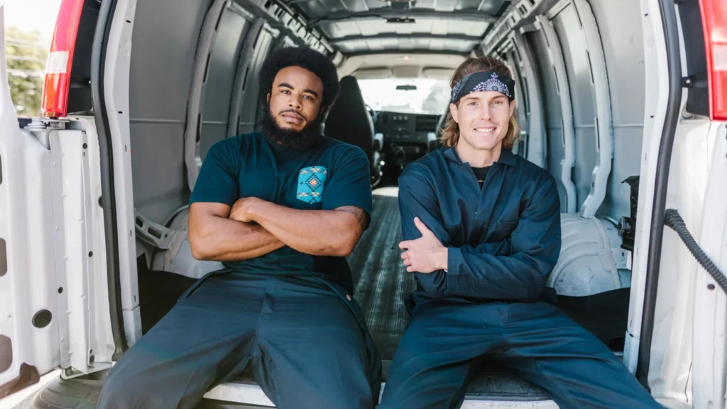 Two men sitting confidently inside an open van, showcasing teamwork and camaraderie — SSK Mechanics guide to How Mobile Servicing Cuts Van Downtime for Tradespeople
