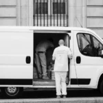 Monochrome image of a delivery van with workers, showcasing urban logistics — SSK Mechanics guide to Emergency Breakdown Cover: What Working Van Owners Should…