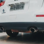 Close-up of a white Mitsubishi Lancer showcasing its exhaust and rear design in an indoor setting — SSK Mechanics guide to AdBlue Explained: A Diesel Owner's Guide
