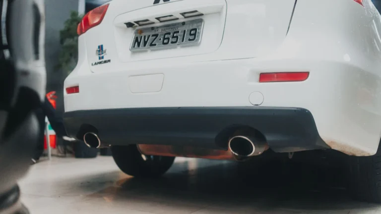 Close-up of a white Mitsubishi Lancer showcasing its exhaust and rear design in an indoor setting — SSK Mechanics guide to AdBlue Explained: A Diesel Owner's Guide