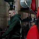 Mechanic in garage inspecting a red truck to ensure optimal performance — SSK Mechanics guide to Diagnostics and Fault Finding for Commercial Vans: Why It Matters
