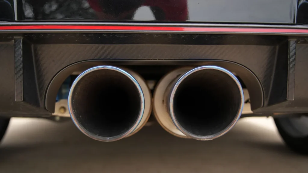 Detailed view of dual exhaust pipes on a sports car, emphasizing power and design — SSK Mechanics guide to What Is an O2 (Lambda) Sensor and What Does It Do