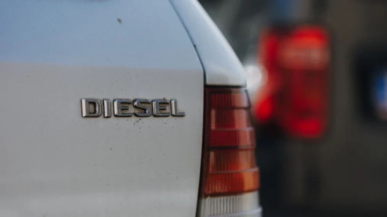 Detailed view of a diesel car badge with blurred background, captured in Prague — SSK Mechanics guide to Short Journeys and Your DPF: Why Stop-Start Driving Causes…