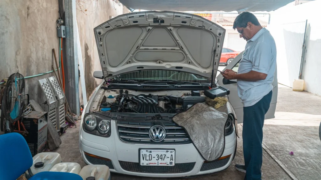 A mechanic examines a Volkswagen engine in a garage setting, focusing on car maintenance — SSK Mechanics guide to The Real Cost of Running a Car: Beyond Just Fuel