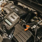 Mechanic diagnosing a car engine with a diagnostic tool, showcasing technical expertise and… — SSK Mechanics guide to Screeching Noise From Your Car: What It Usually Means