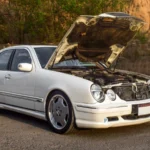 White Mercedes Benz car with hood open, parked outdoors in Rawalpindi, Pakistan — SSK Mechanics guide to RAC Mobile Mechanics vs Independent Mobile Mechanics: What…