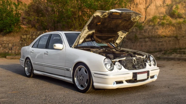 White Mercedes Benz car with hood open, parked outdoors in Rawalpindi, Pakistan — SSK Mechanics guide to RAC Mobile Mechanics vs Independent Mobile Mechanics: What…