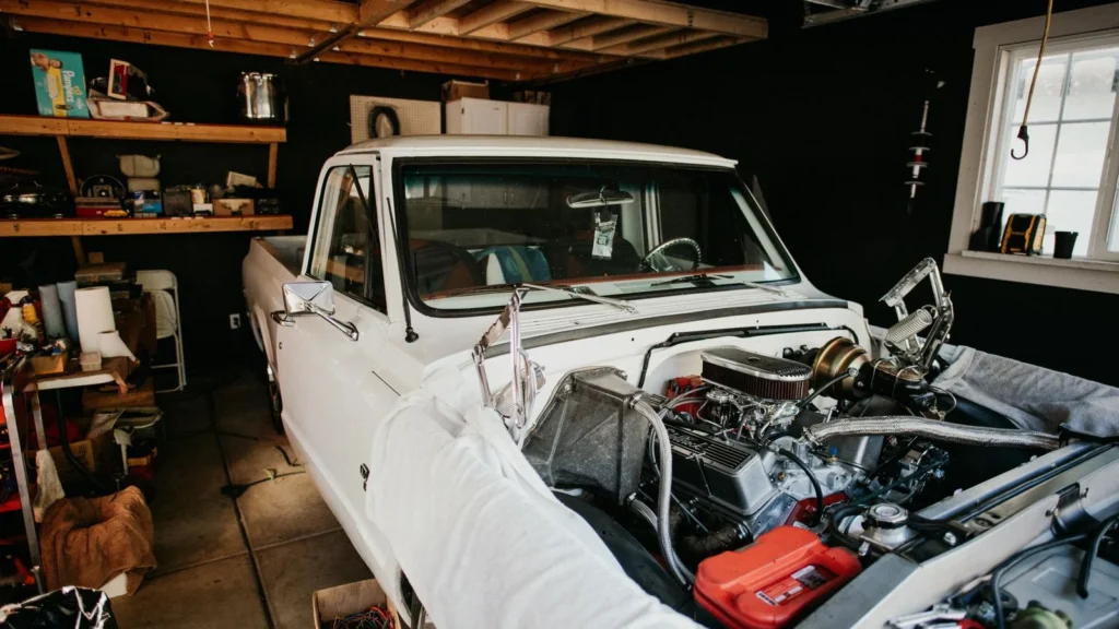 A vintage pickup truck undergoing engine repairs in a well-equipped home garage — SSK Mechanics guide to AA Vehicle Inspection vs a Mobile Mechanic Pre-Purchase…