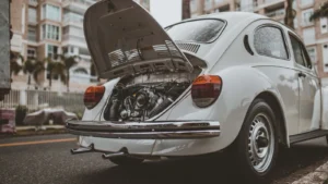 Old-fashioned vintage car with open engine hood on a city street in Curitiba, Brazil — SSK Mechanics guide to ClickMechanic Car Inspection vs SSK Mechanics: Comparing…