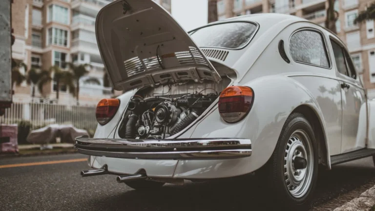 Old-fashioned vintage car with open engine hood on a city street in Curitiba, Brazil — SSK Mechanics guide to ClickMechanic Car Inspection vs SSK Mechanics: Comparing…