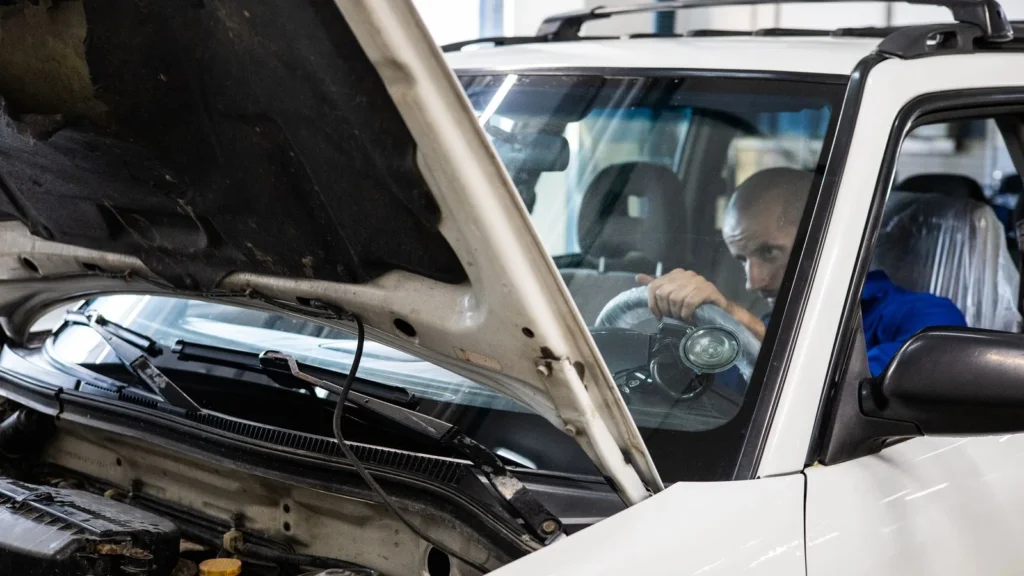 A mechanic performs a detailed inspection on a vehicle in a workshop setting — SSK Mechanics guide to HPI Check Services vs a Full Mechanical Pre-Purchase…