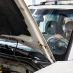 A mechanic performs a detailed inspection on a vehicle in a workshop setting — SSK Mechanics guide to HPI Check Services vs a Full Mechanical Pre-Purchase…
