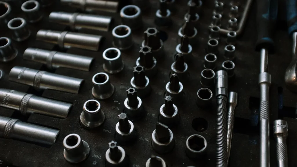 Close-up of assorted metal tools in an organized workshop setting, ideal for mechanical repairs — SSK Mechanics guide to National Chains vs Local Mobile Mechanics in Bradford, Leeds…