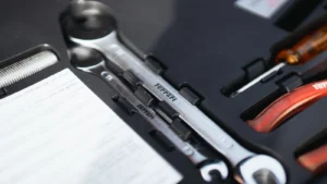 Detailed view of Ferrari-branded wrenches in a toolkit box, highlighting sports car maintenance… — SSK Mechanics guide to YouTube DIY Fixes vs a Professional Mobile Mechanic: Where…