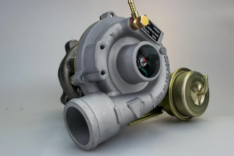 A turbocharger and boost control solenoid in a car engine bay