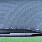 A business van undergoing a winter check with frost visible on the windscreen